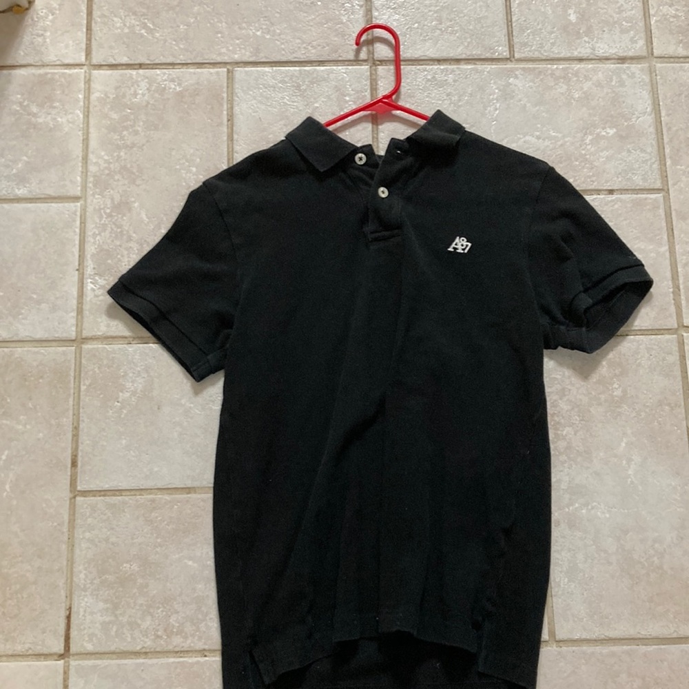 Black polo shirt it’s a little worn